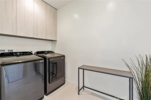 a bedroom with a bed television and a large window