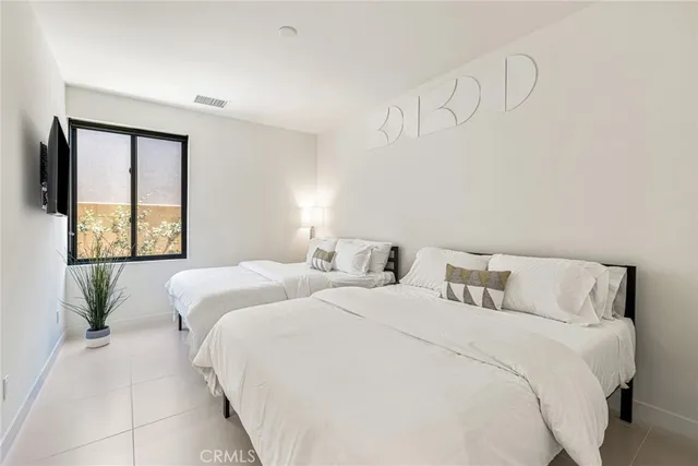 a bathroom with a sink a toilet a mirror and shower