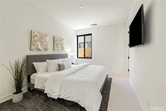 a bathroom with a sink a toilet a mirror and shower