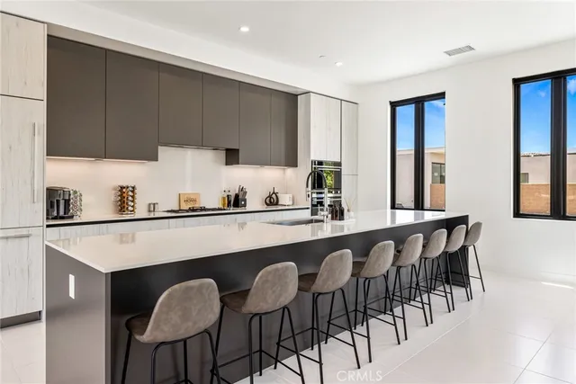 a kitchen with a table chairs sink and cabinets