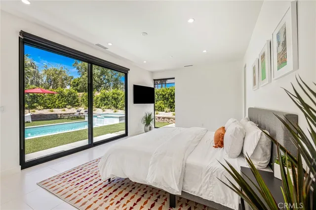 a bedroom with a large bed and a large window