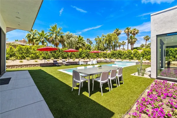 a view of a chairs and table in the patio