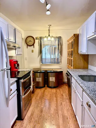 a kitchen with stainless steel appliances granite countertop a stove and a sink