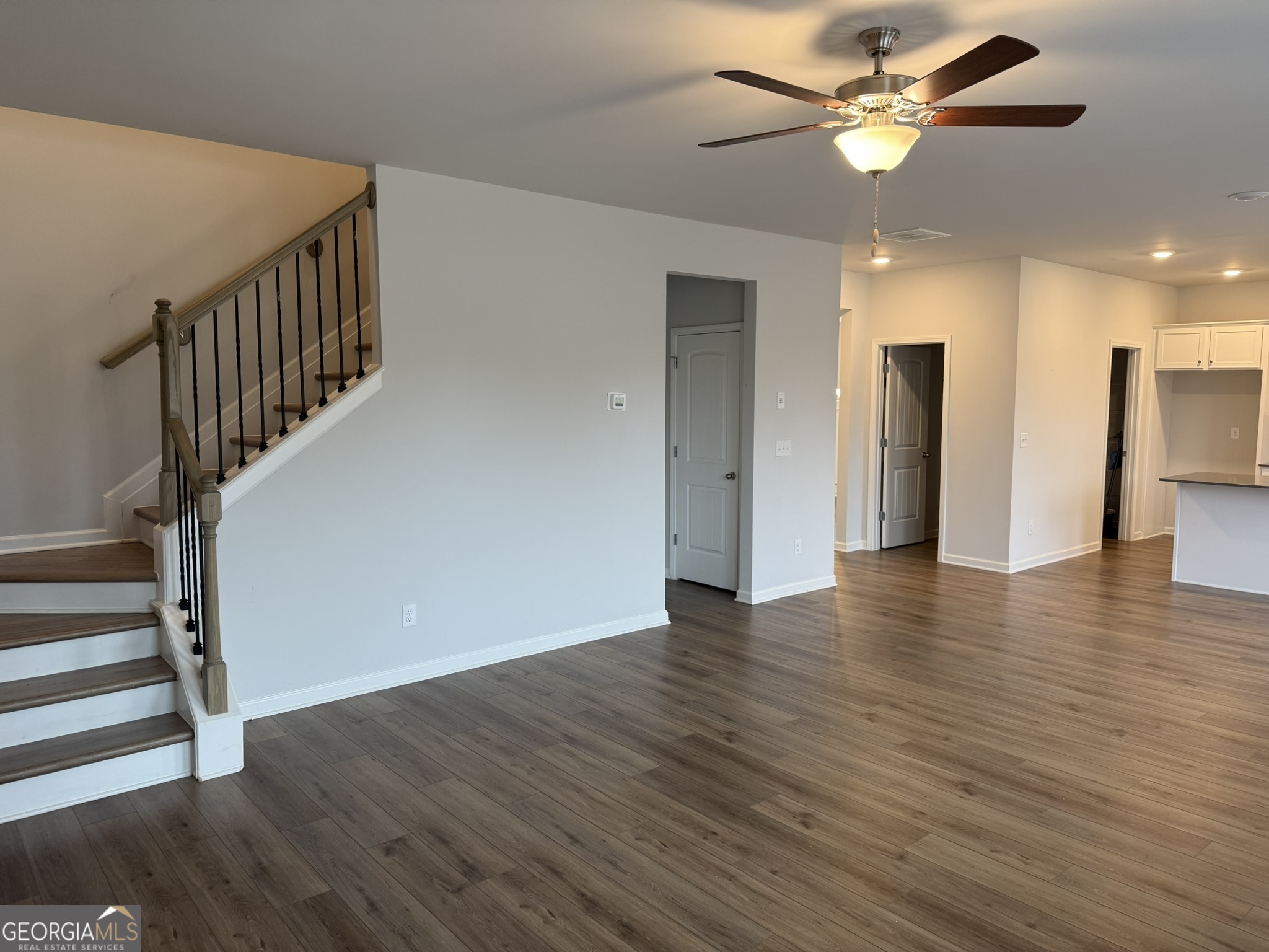 417 Sawmill Trace Hampton, GA 30228 - Photo 13 of 27 a view of an empty room with wooden floor and a ceiling fan