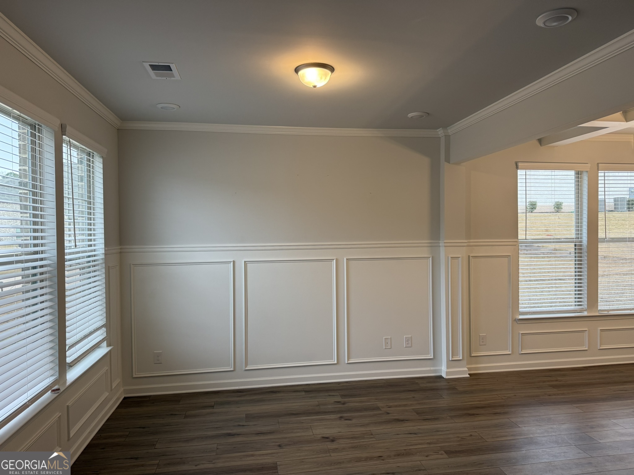 417 Sawmill Trace Hampton, GA 30228 - Photo 4 of 27 a view of an empty room with wooden floor and a window