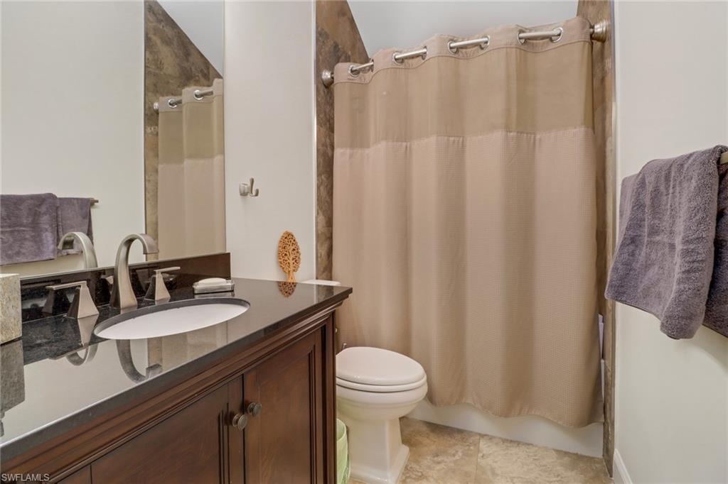 1275 Cobia Court Naples, FL 34102 - Photo 21 of 25 Bathroom with vanity and shower / tub combo with curtain