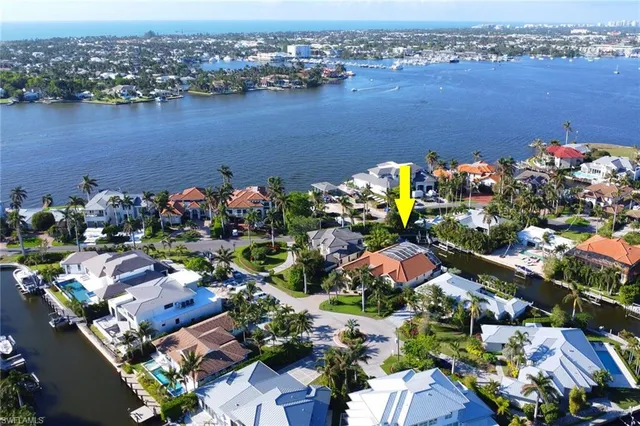 an aerial view of lake and residential houses with outdoor space
