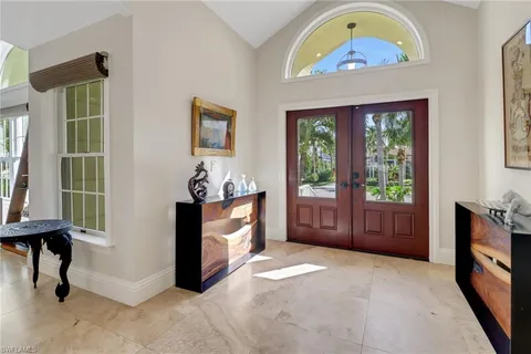 a view of an entryway with wooden floor and a front door