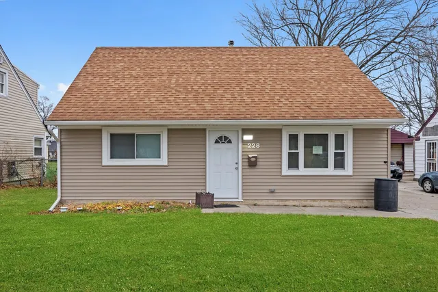 a view of house with a backyard