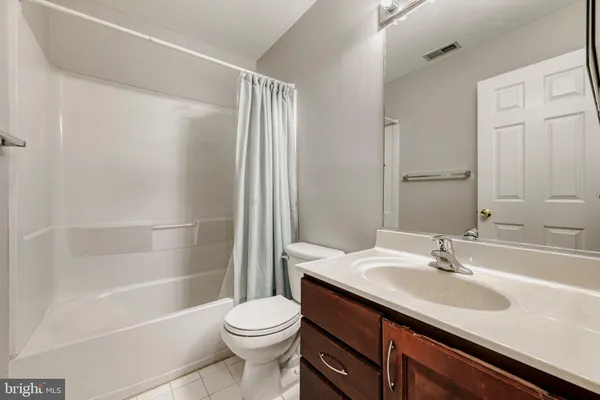 a spacious bathroom with a granite countertop tub sink shower and mirror
