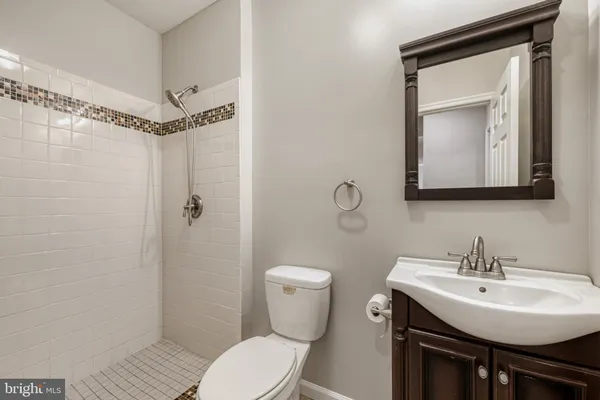 a bathroom with a tub a sink double vanity and a mirror