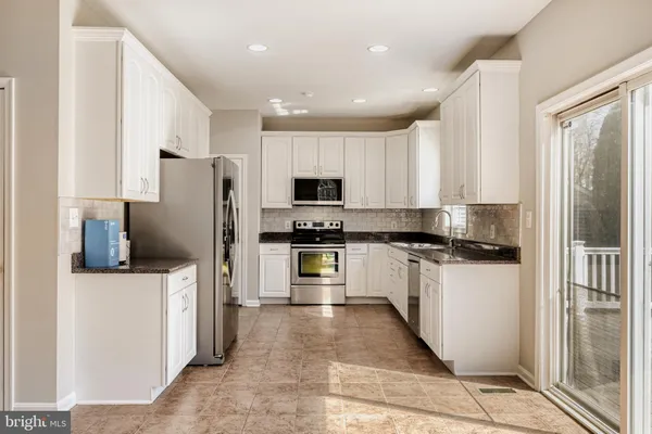 a kitchen with stainless steel appliances a refrigerator stove microwave and sink