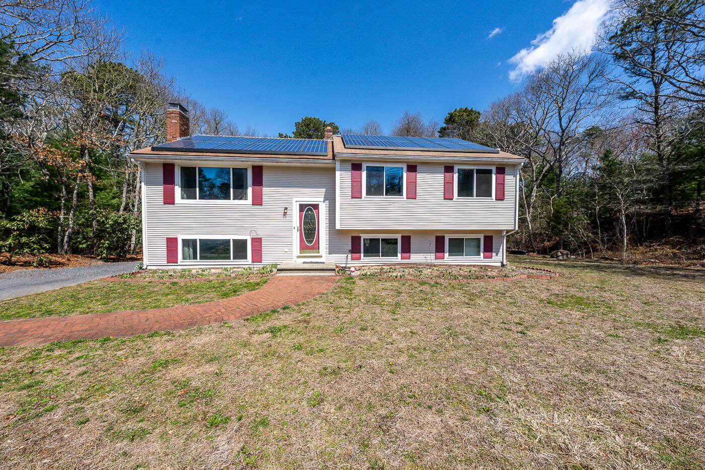 a front view of brick house with a yard