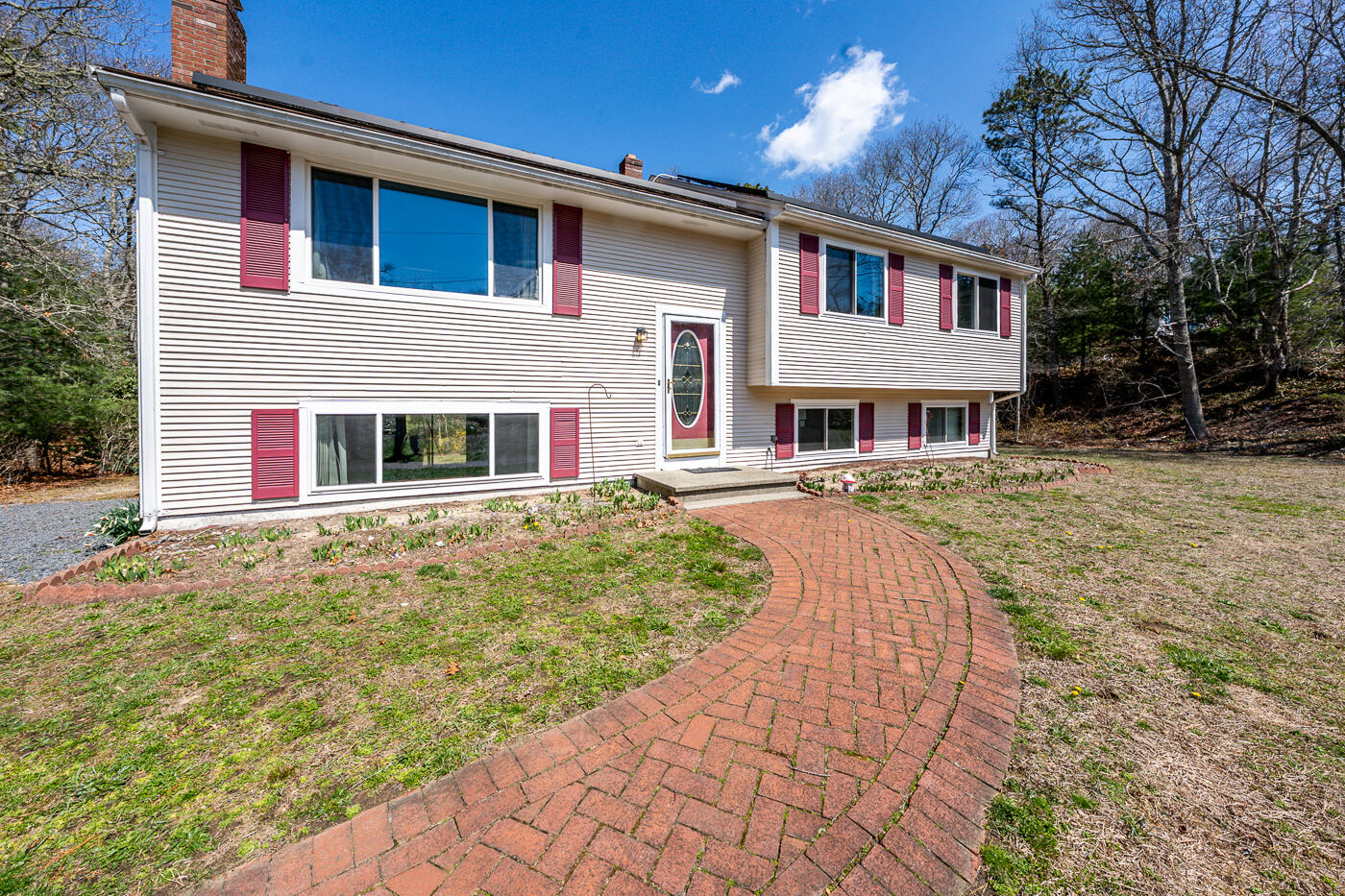 27 Howard Avenue Monument Beach, MA 02532 - Photo 2 of 24 a front view of a house with a yard