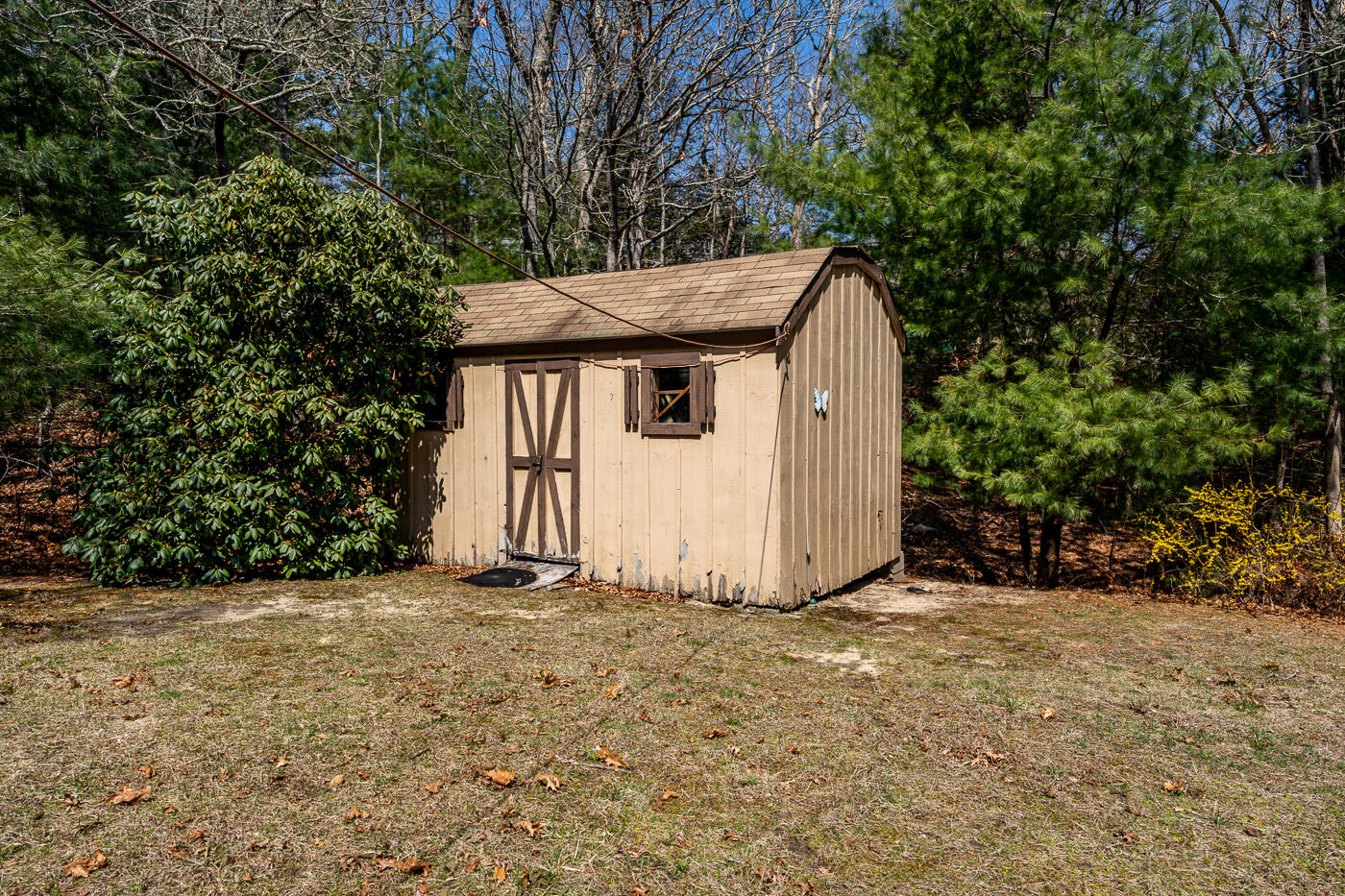 27 Howard Avenue Monument Beach, MA 02532 - Photo 22 of 24 a view of a small house in the middle of a yard