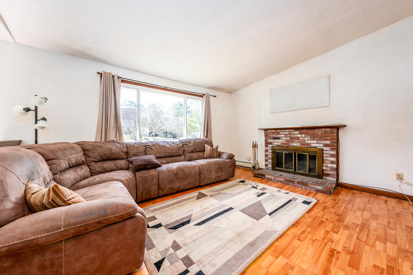27 Howard Avenue Monument Beach, MA 02532 - Photo 3 of 24 a living room with furniture and a fireplace