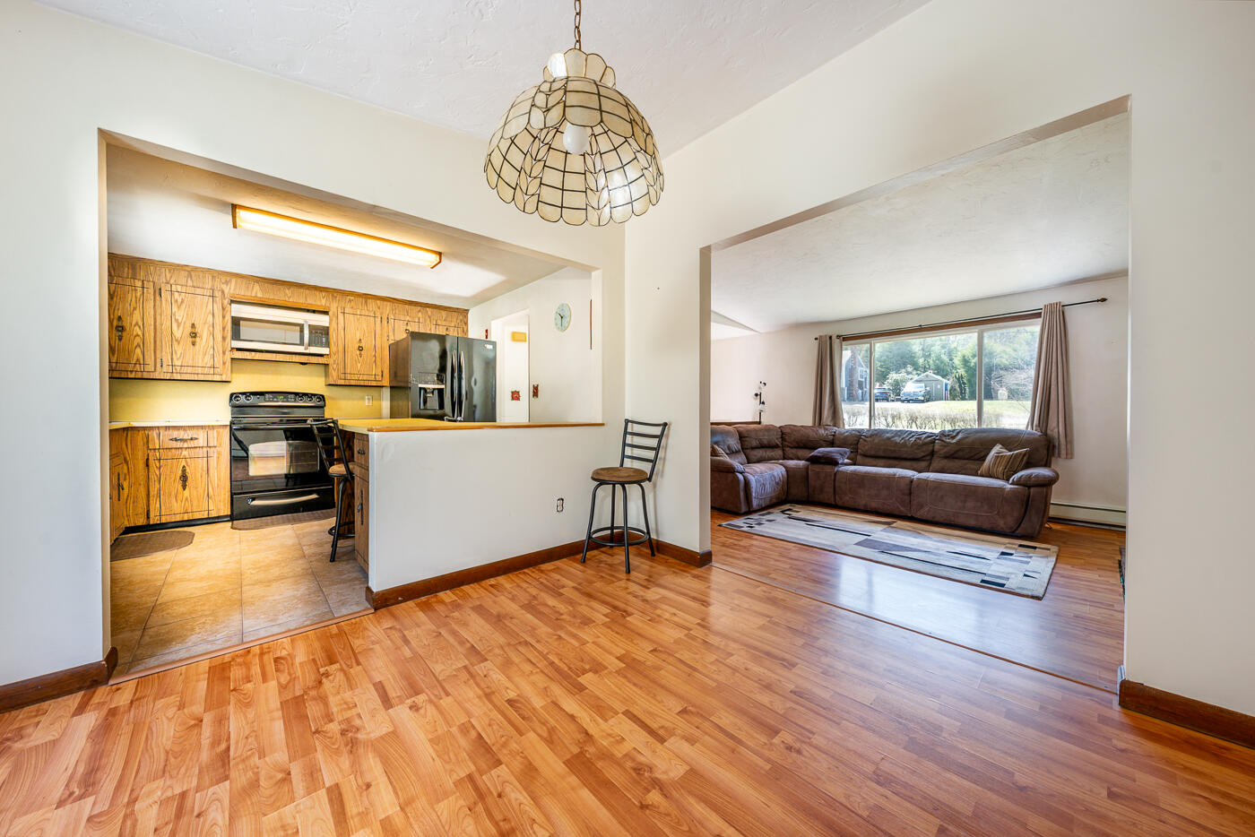 27 Howard Avenue Monument Beach, MA 02532 - Photo 4 of 24 a living room with furniture and a chandelier