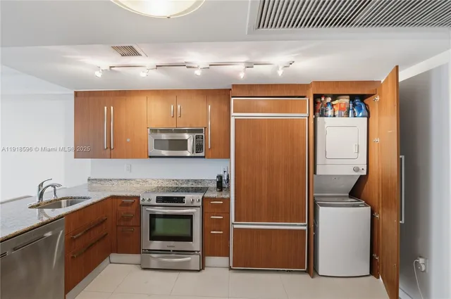 a kitchen with stainless steel appliances granite countertop a stove and a sink