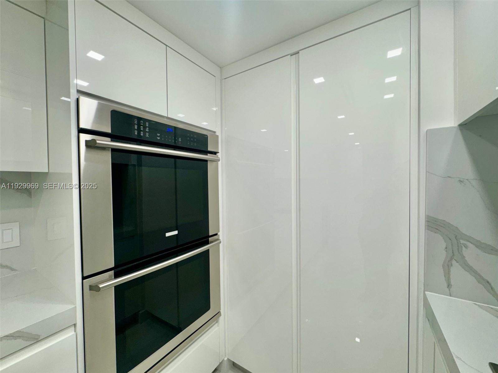 9801 Collins Avenue, Unit 5U Bal Harbour, FL 33154 - Photo 11 of 62 a bathroom with a shower and stove