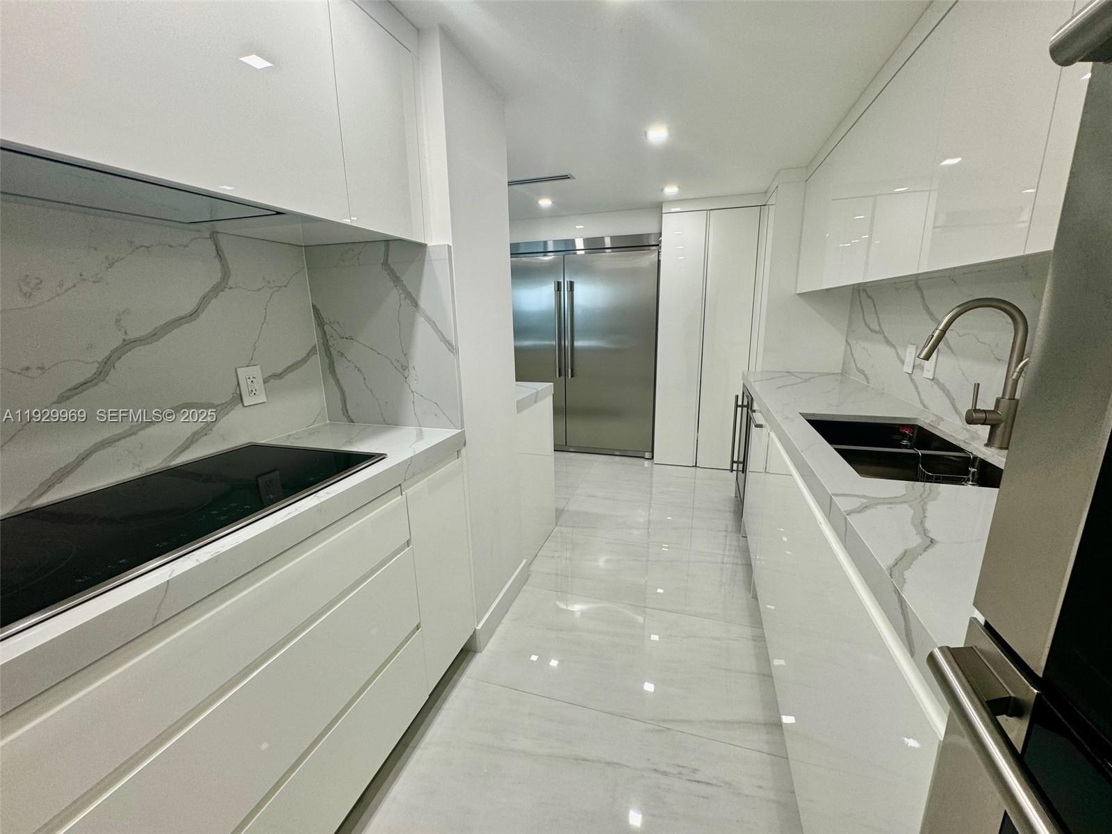 9801 Collins Avenue, Unit 5U Bal Harbour, FL 33154 - Photo 12 of 62 a kitchen with stainless steel appliances cabinets and a sink