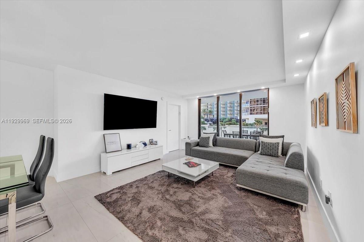 9801 Collins Avenue, Unit 5U Bal Harbour, FL 33154 - Photo 15 of 80 a living room with furniture and a flat screen tv