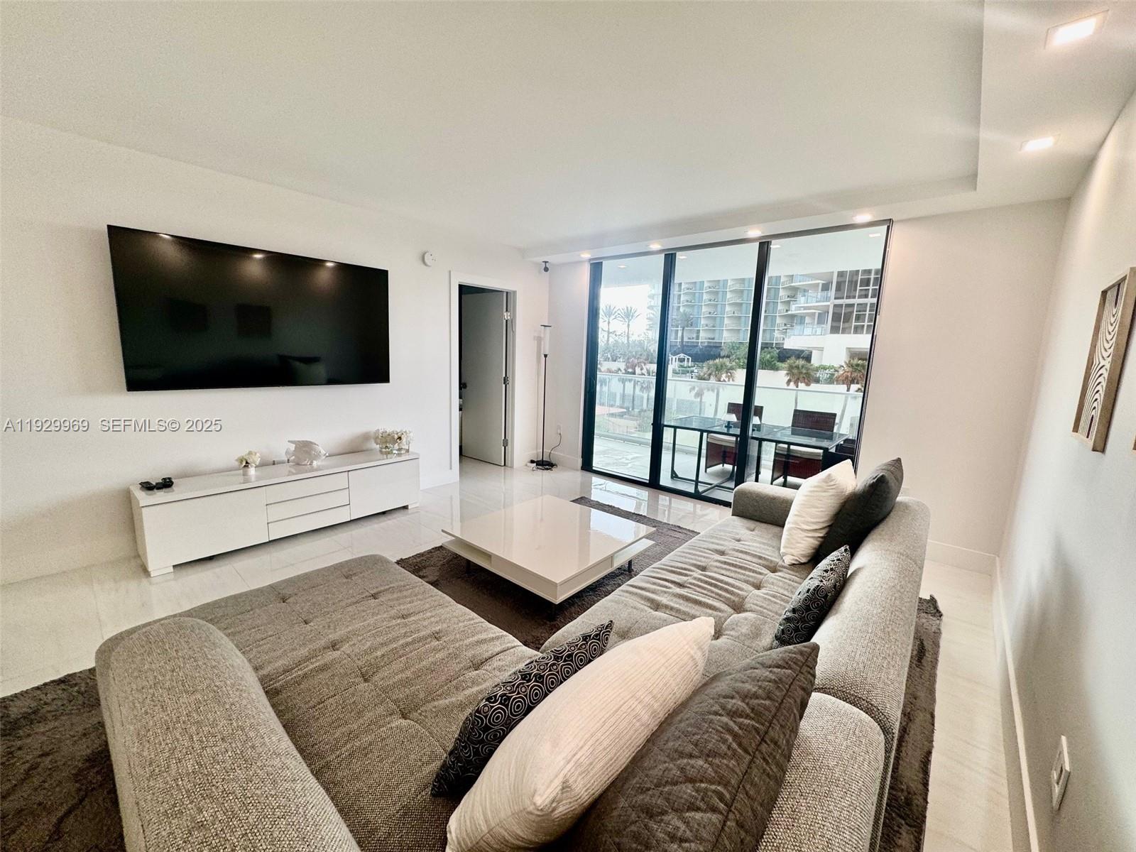 9801 Collins Avenue, Unit 5U Bal Harbour, FL 33154 - Photo 17 of 62 a living room with furniture and a flat screen tv