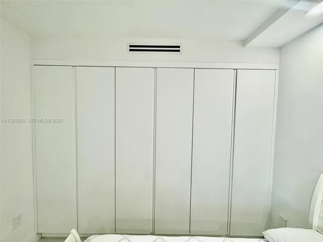 a bedroom with a bed and a window in it