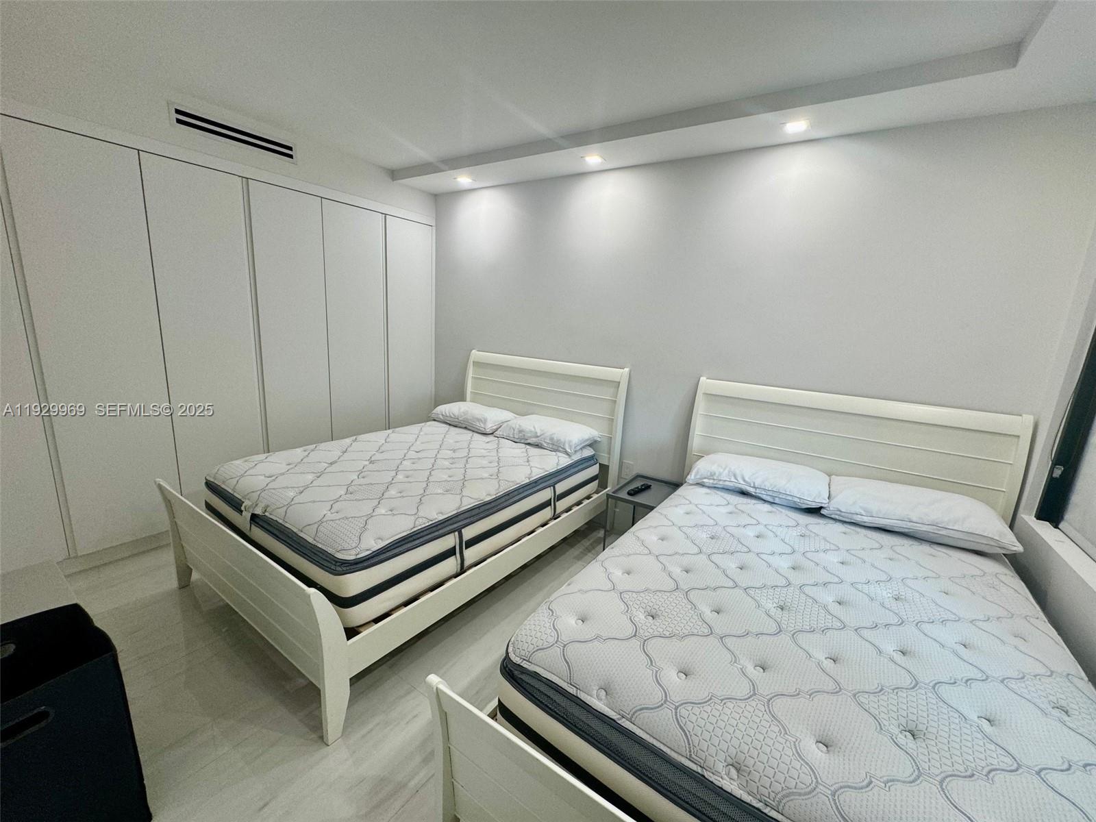 9801 Collins Avenue, Unit 5U Bal Harbour, FL 33154 - Photo 19 of 62 a bedroom with a bed and a window in it