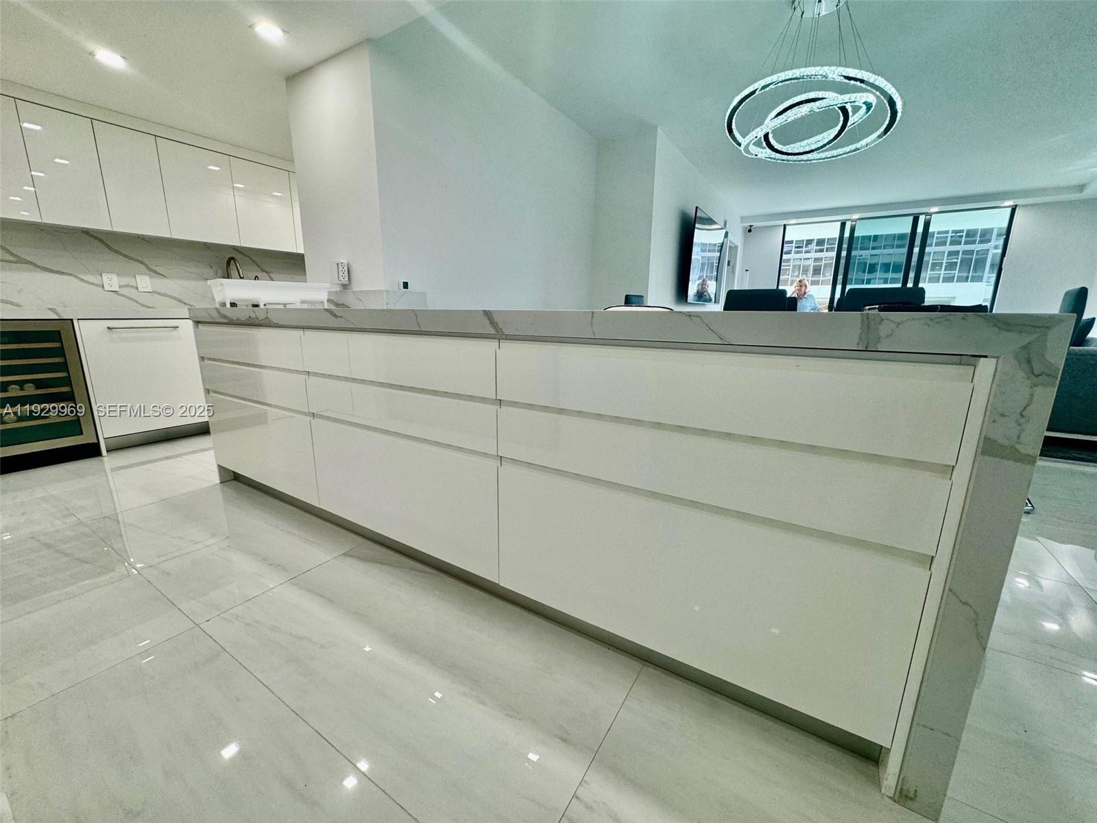 9801 Collins Avenue, Unit 5U Bal Harbour, FL 33154 - Photo 20 of 62 a kitchen with stainless steel appliances granite countertop a sink a stove and cabinets