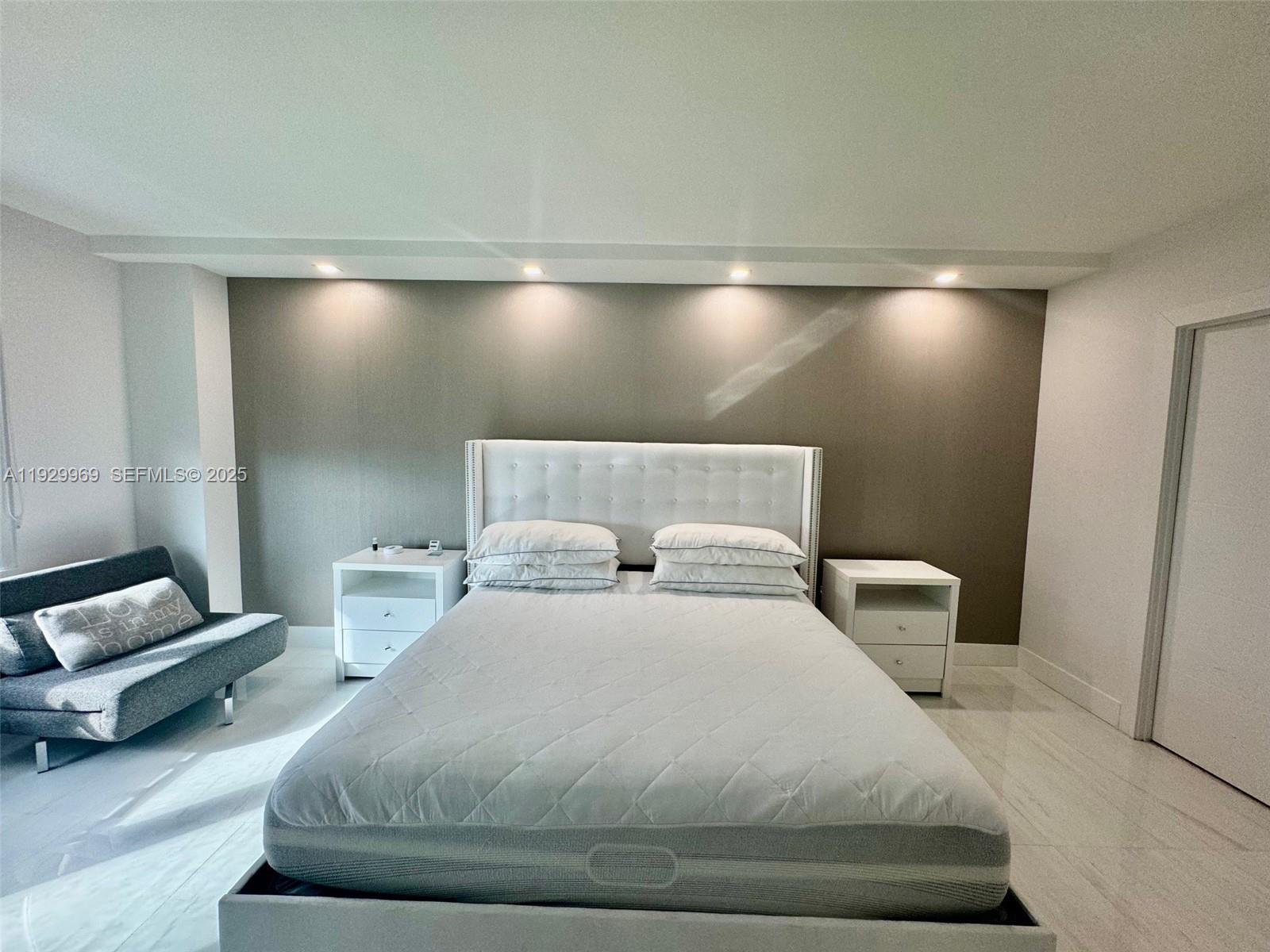 9801 Collins Avenue, Unit 5U Bal Harbour, FL 33154 - Photo 26 of 62 a bedroom with a bed and a couch