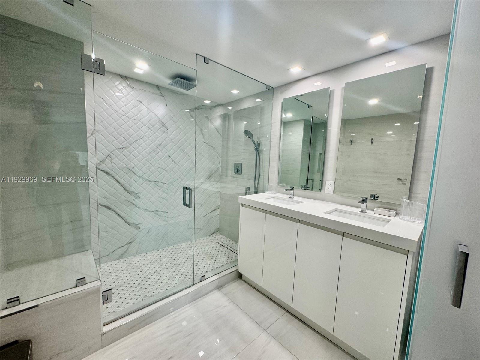 9801 Collins Avenue, Unit 5U Bal Harbour, FL 33154 - Photo 28 of 62 a bathroom with a shower sink and mirror