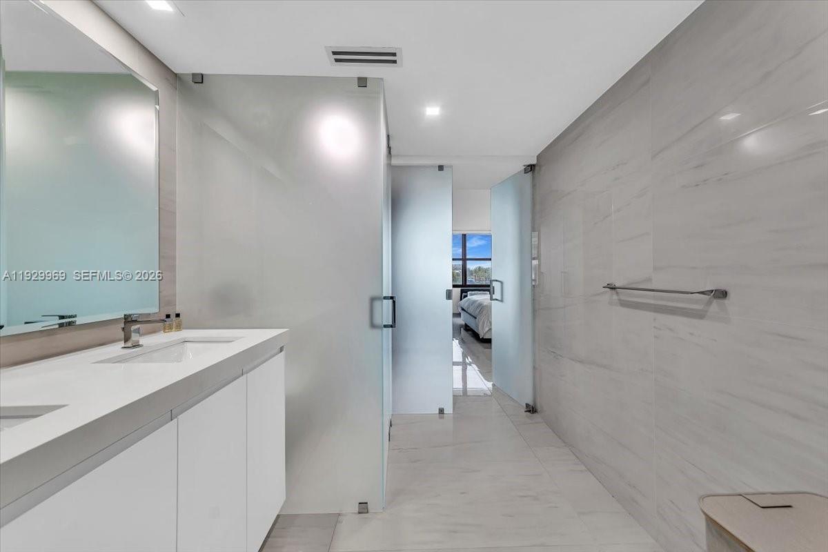 9801 Collins Avenue, Unit 5U Bal Harbour, FL 33154 - Photo 34 of 80 a bathroom with a sink and a mirror