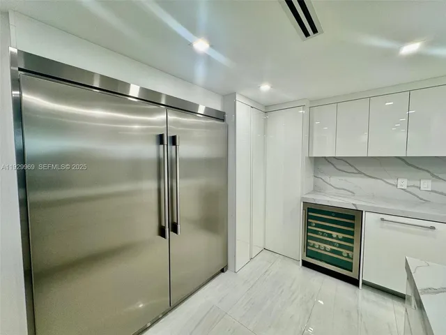 a kitchen with a refrigerator and a sink