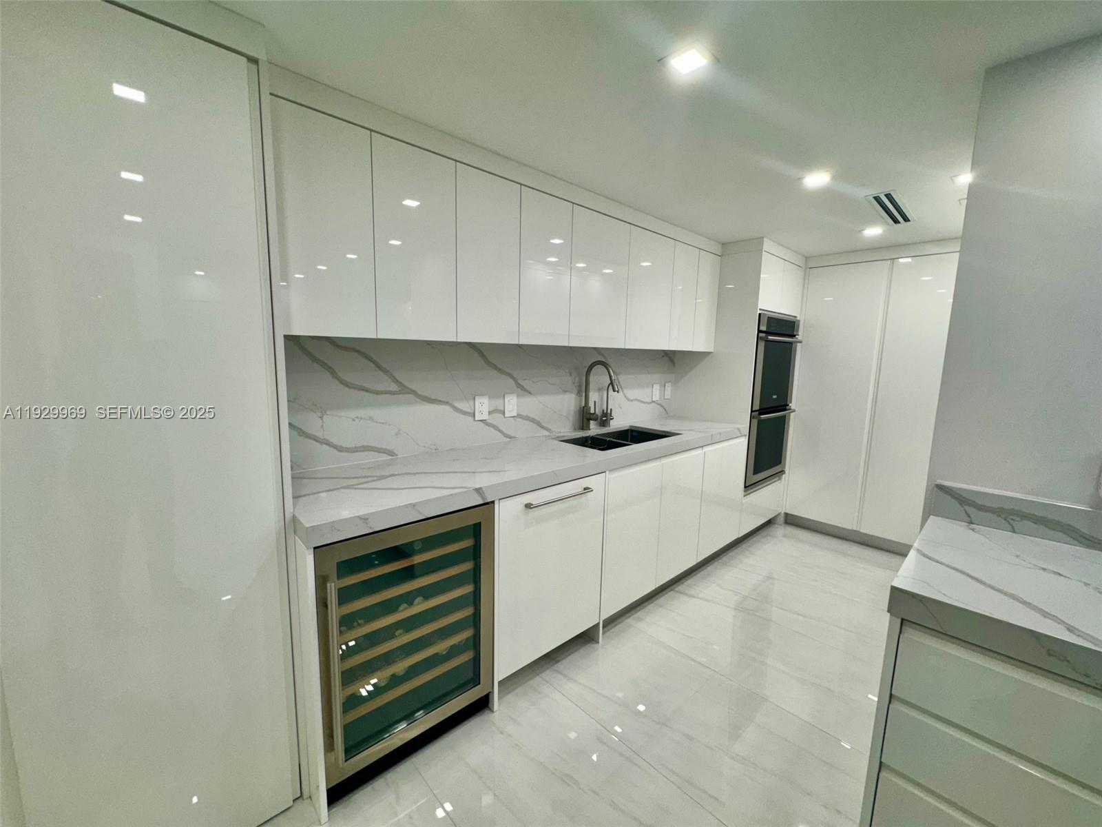 9801 Collins Avenue, Unit 5U Bal Harbour, FL 33154 - Photo 7 of 62 a kitchen with a refrigerator and a sink