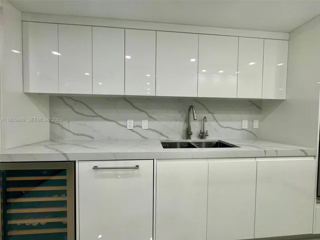 a utility room with cabinets washer and dryer