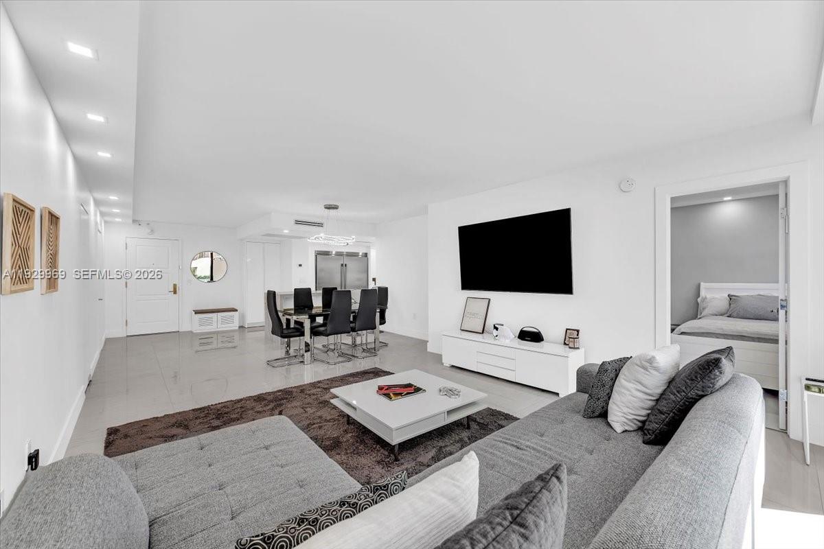 9801 Collins Avenue, Unit 5U Bal Harbour, FL 33154 - Photo 9 of 80 a living room with furniture and a flat screen tv