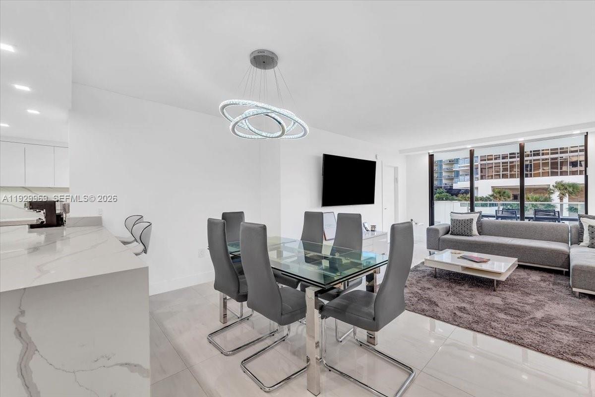 9801 Collins Avenue, Unit 5U Bal Harbour, FL 33154 - Photo 10 of 80 a view of a livingroom with furniture and a flat screen tv