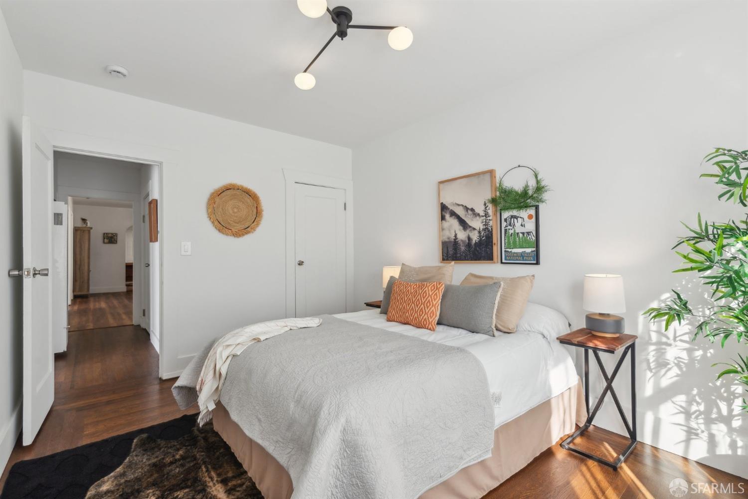 1521 Mitchell Street Oakland, CA 94601 - Photo 12 of 28 a bedroom with a bed and a potted plant