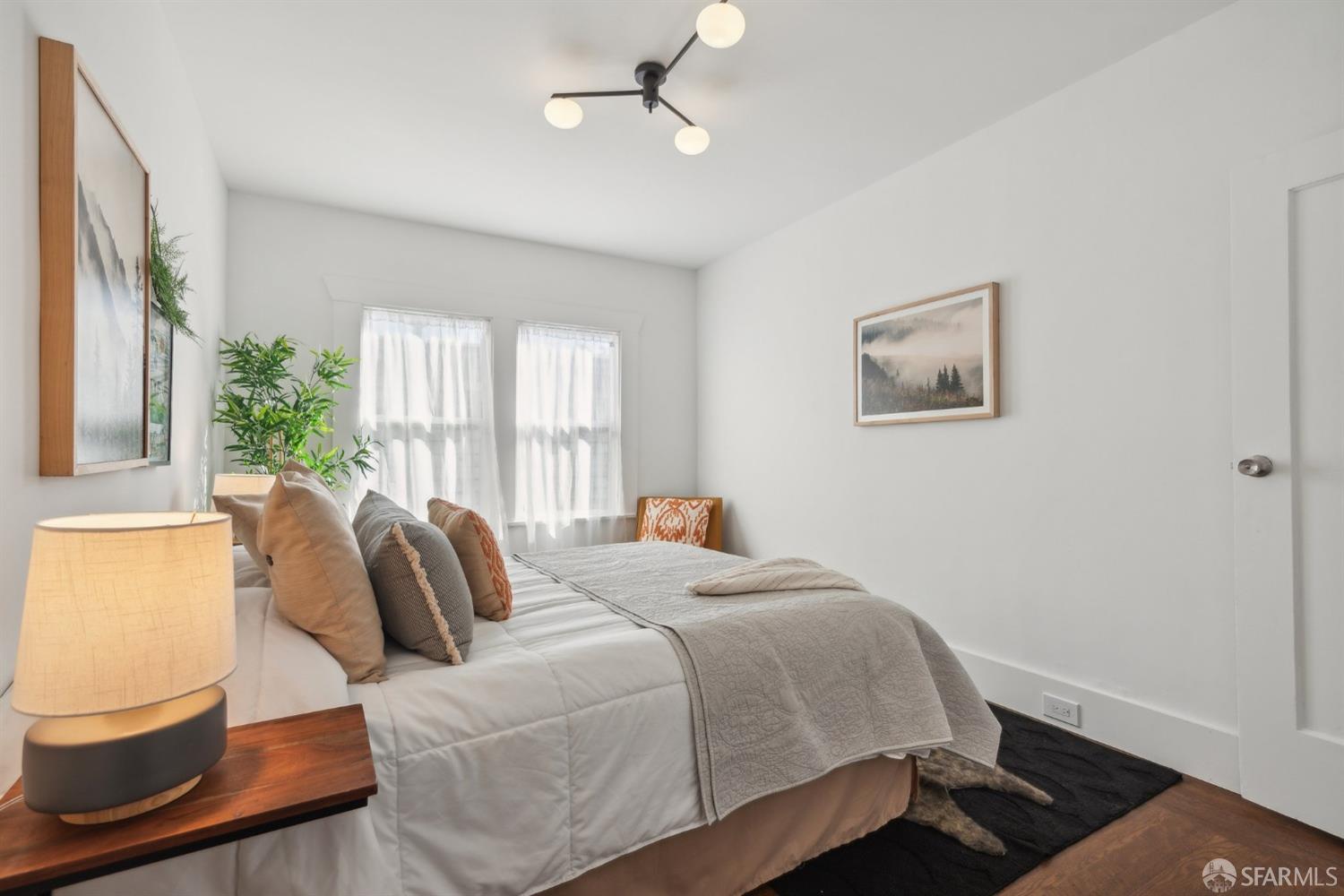 1521 Mitchell Street Oakland, CA 94601 - Photo 13 of 28 a bedroom with a bed and wooden floor
