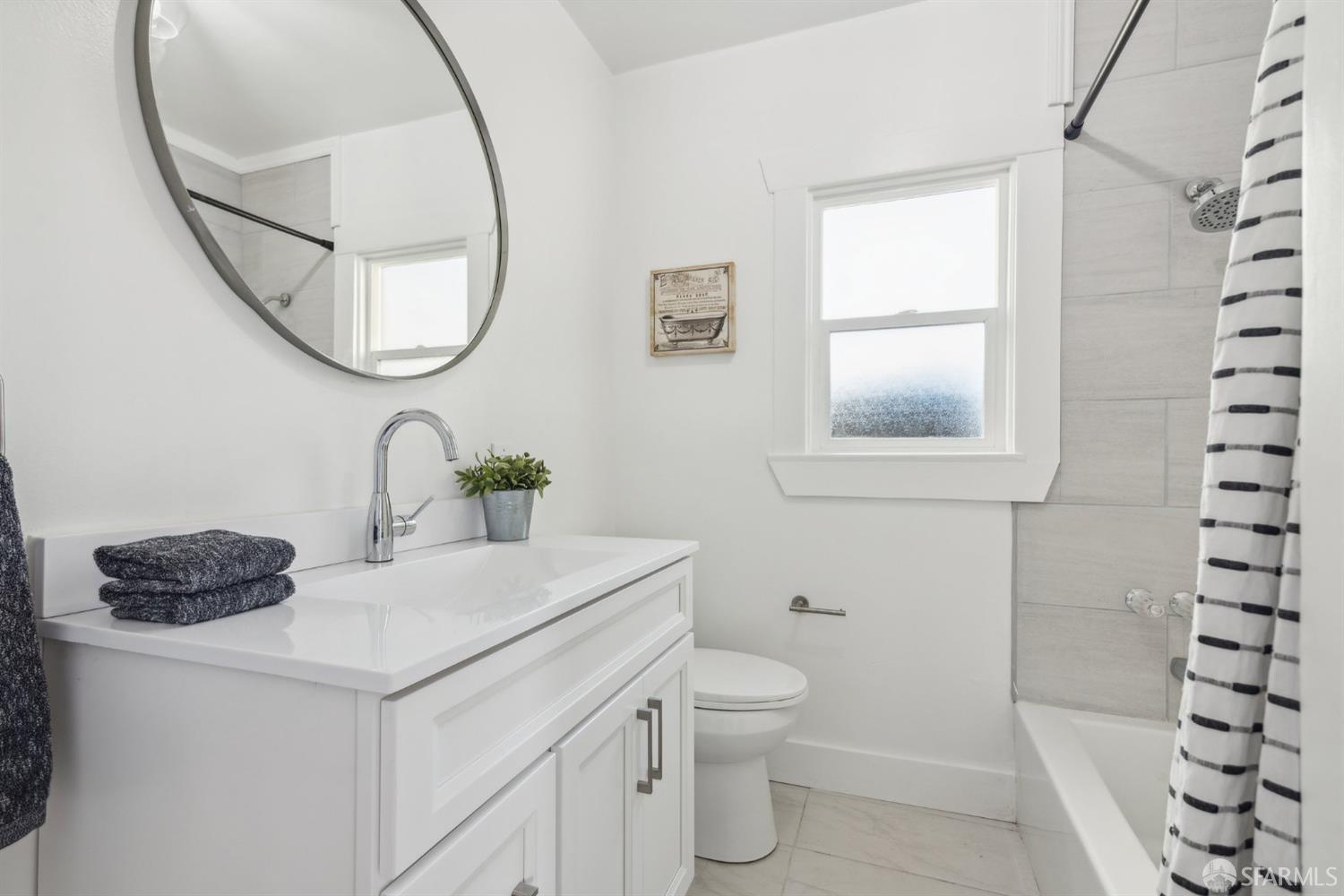1521 Mitchell Street Oakland, CA 94601 - Photo 14 of 28 a bathroom with a sink a toilet and a mirror