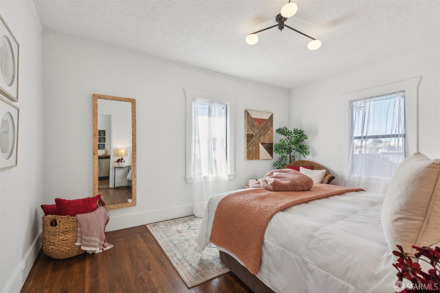 1521 Mitchell Street Oakland, CA 94601 - Photo 17 of 28 a bedroom with a bed and wooden floor