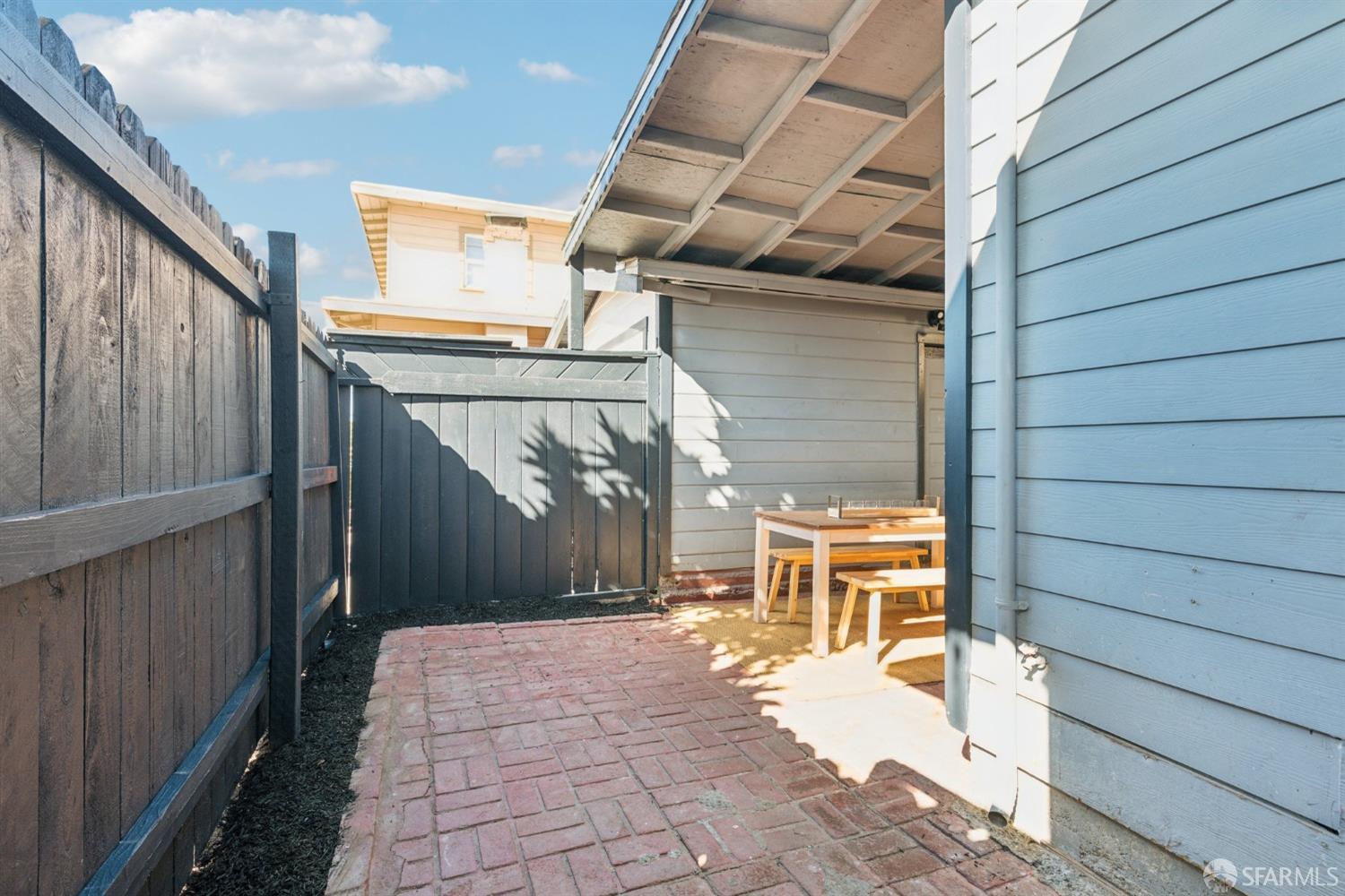 1521 Mitchell Street Oakland, CA 94601 - Photo 25 of 28 a view of a patio with table and chairs with wooden floor and fence