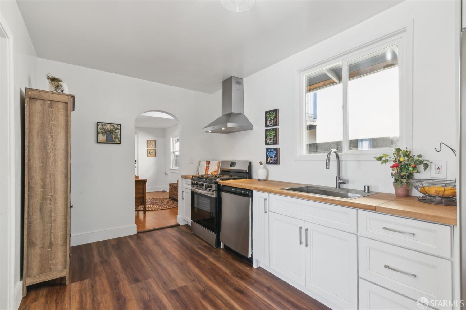 1521 Mitchell Street Oakland, CA 94601 - Photo 8 of 28 a kitchen with stainless steel appliances white cabinets and a window