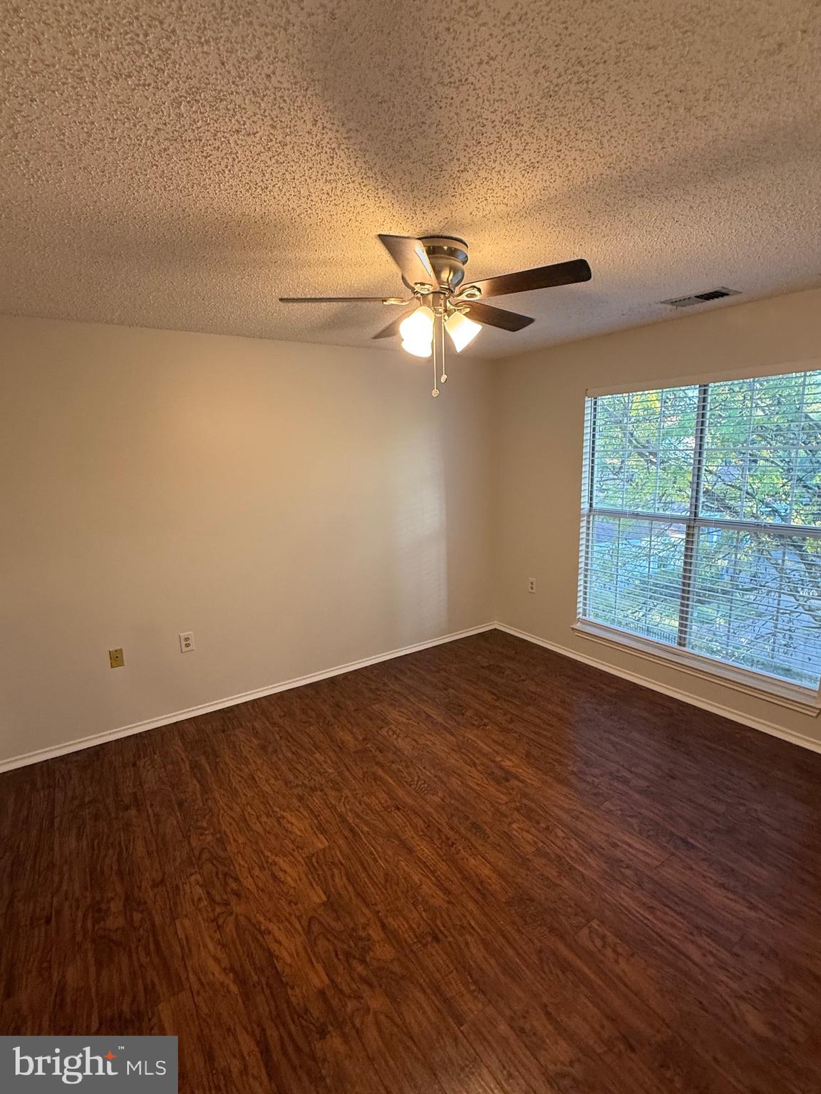 21029 Timber Ridge Terrace, Unit 302 Ashburn, VA 20147 - Photo 5 of 14 an empty room with wooden floor and windows