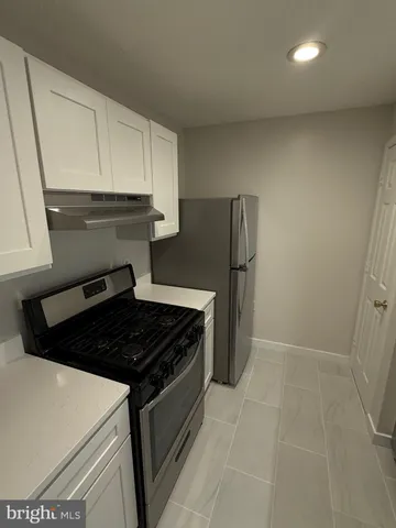 a kitchen with a stove and a refrigerator