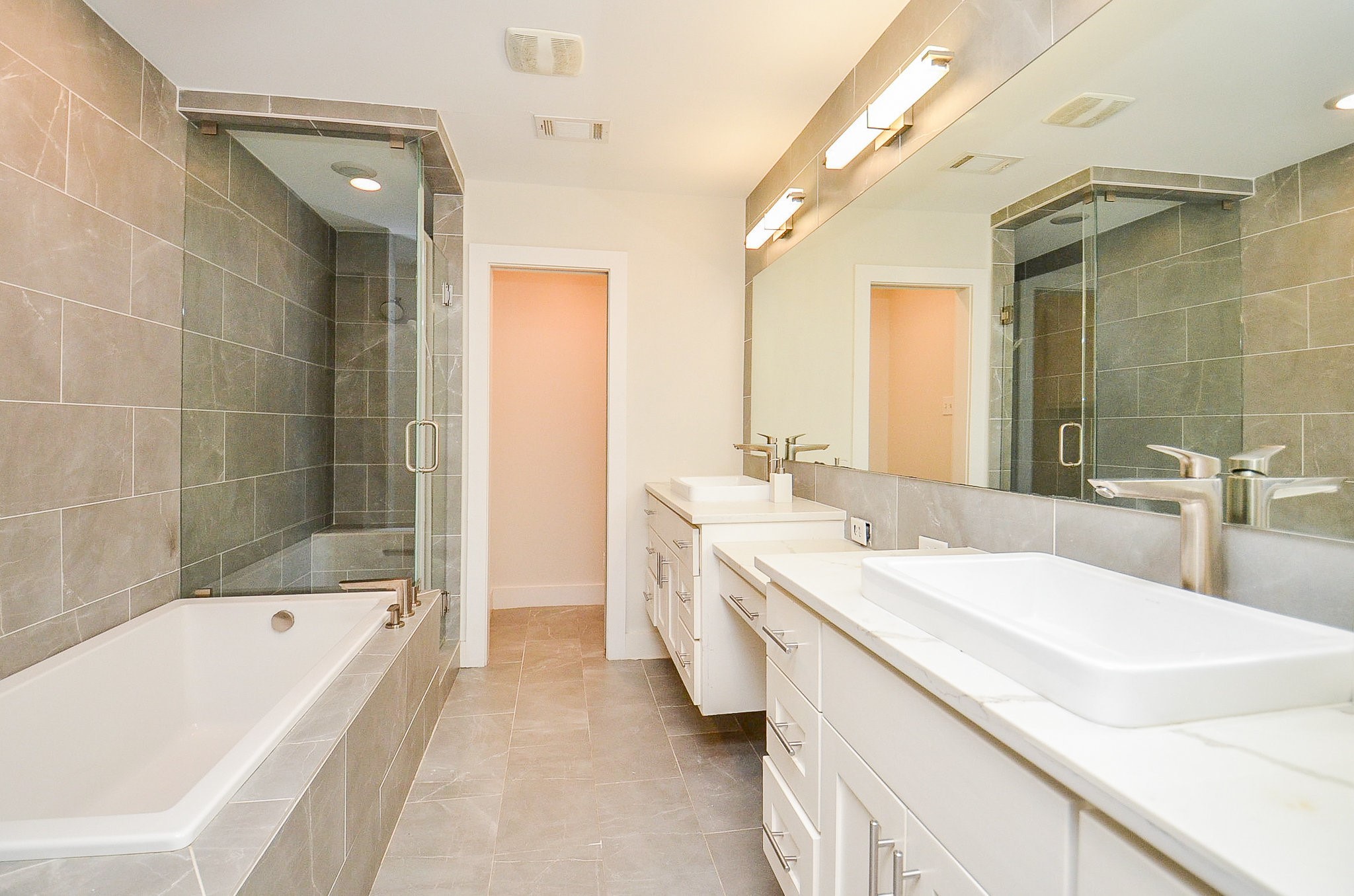 10003 Burgoyne Road Houston, TX 77042 - Photo 24 of 48 a spacious bathroom with a tub sink shower and mirror