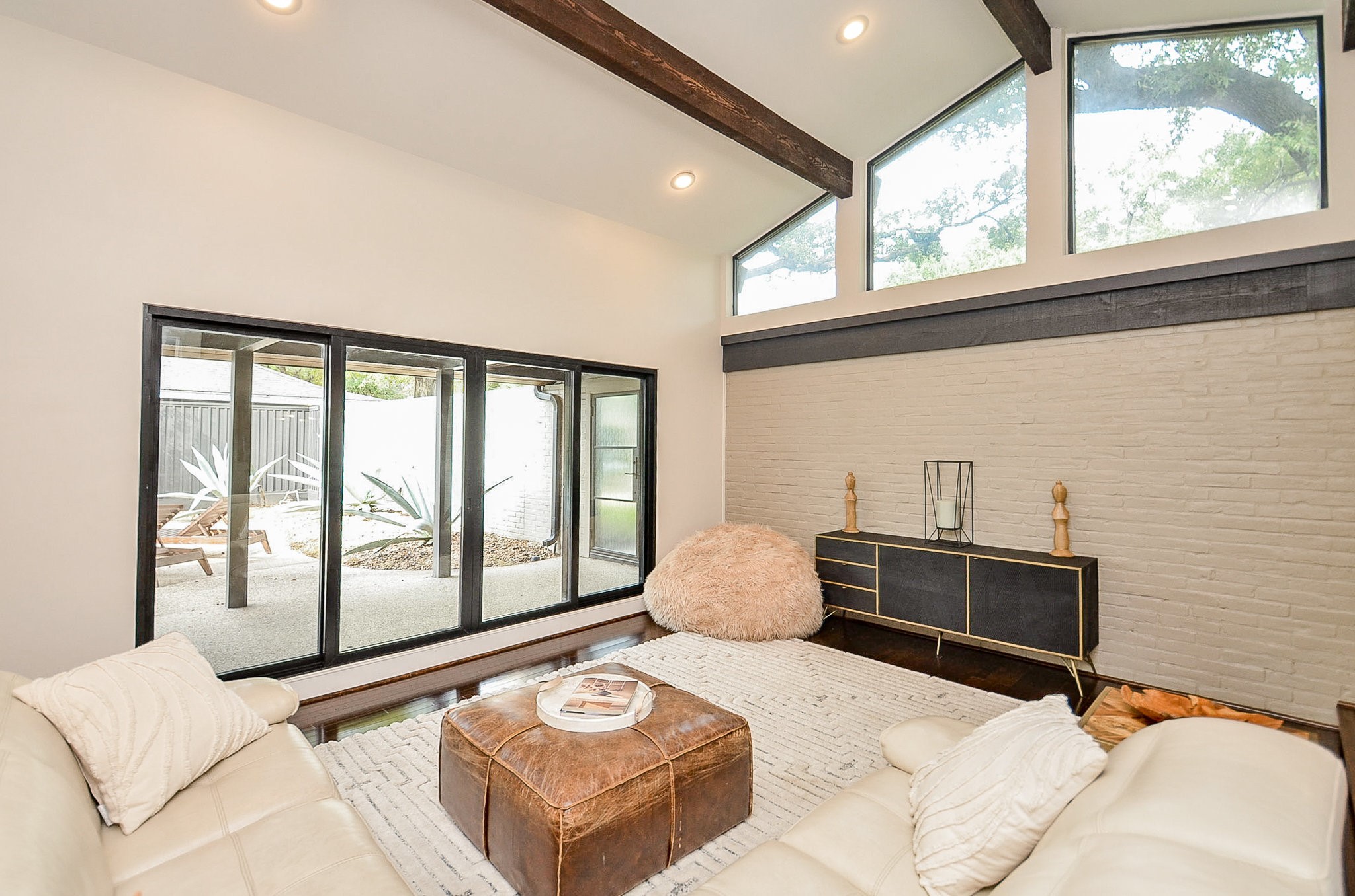 10003 Burgoyne Road Houston, TX 77042 - Photo 3 of 48 Expansive glass doors open to the pool courtyard, creating a serene indoor–outdoor connection that feels both private and calming