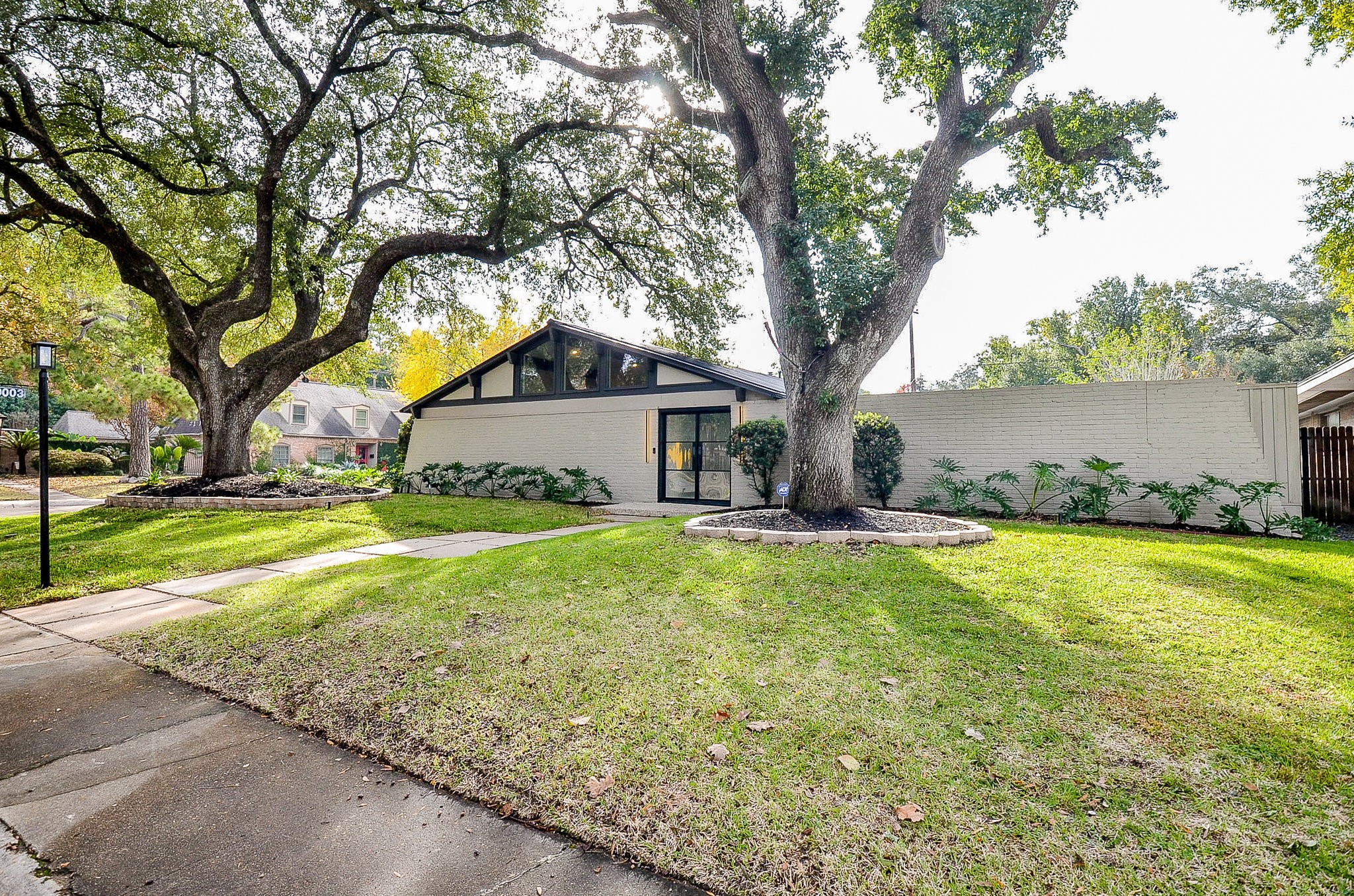 10003 Burgoyne Road Houston, TX 77042 - Photo 42 of 48 a view of backyard of house with green space