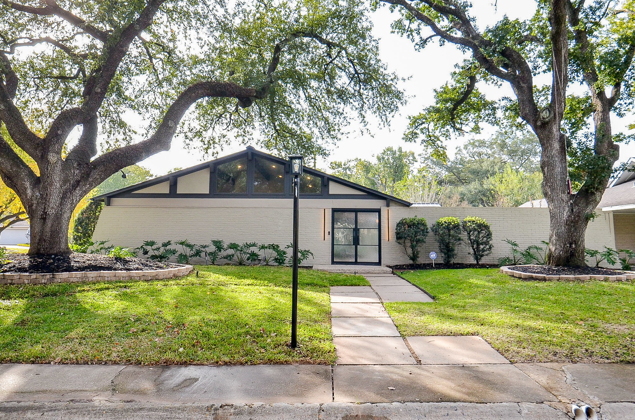 10003 Burgoyne Road Houston, TX 77042 - Photo 6 of 48 a front view of house with yard and trees in the background