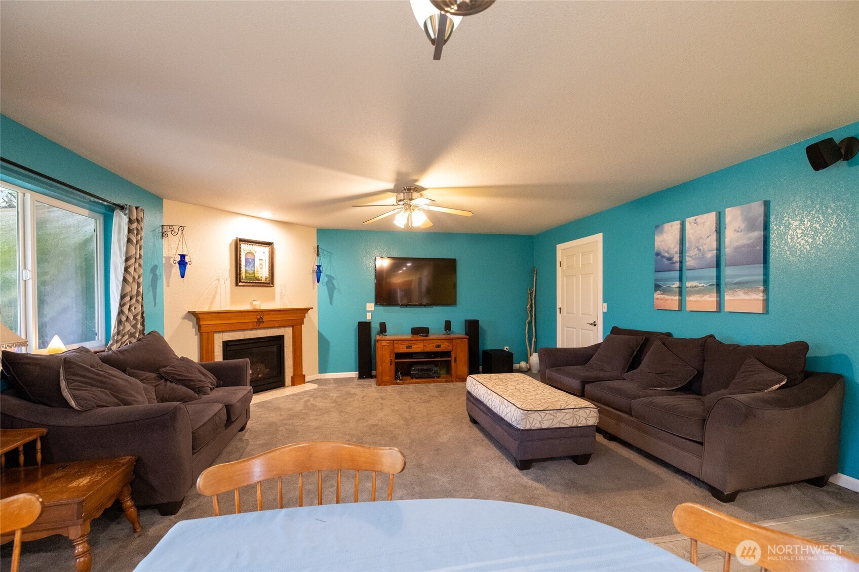 7332 183rd Avenue Southwest Rochester, WA 98579 - Photo 13 of 40 a living room with furniture a fireplace and a flat screen tv